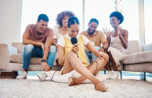 laughing or friends singing in home living room together